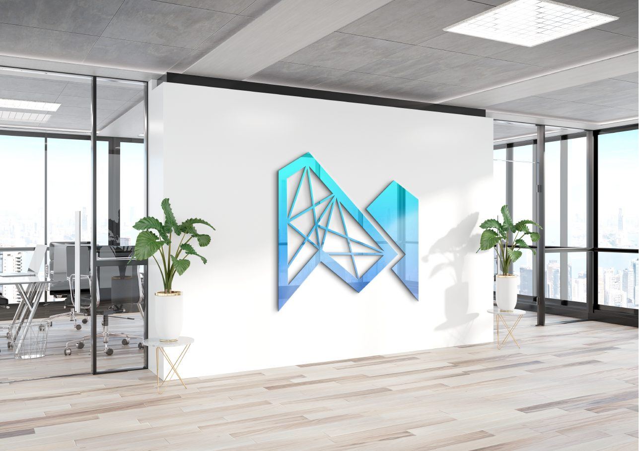 The Meritore mark on a white office wall